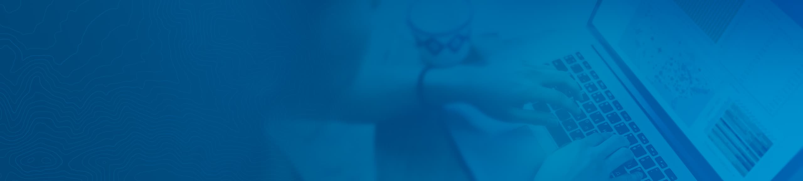 Banner of person's hands on laptop keyboard.